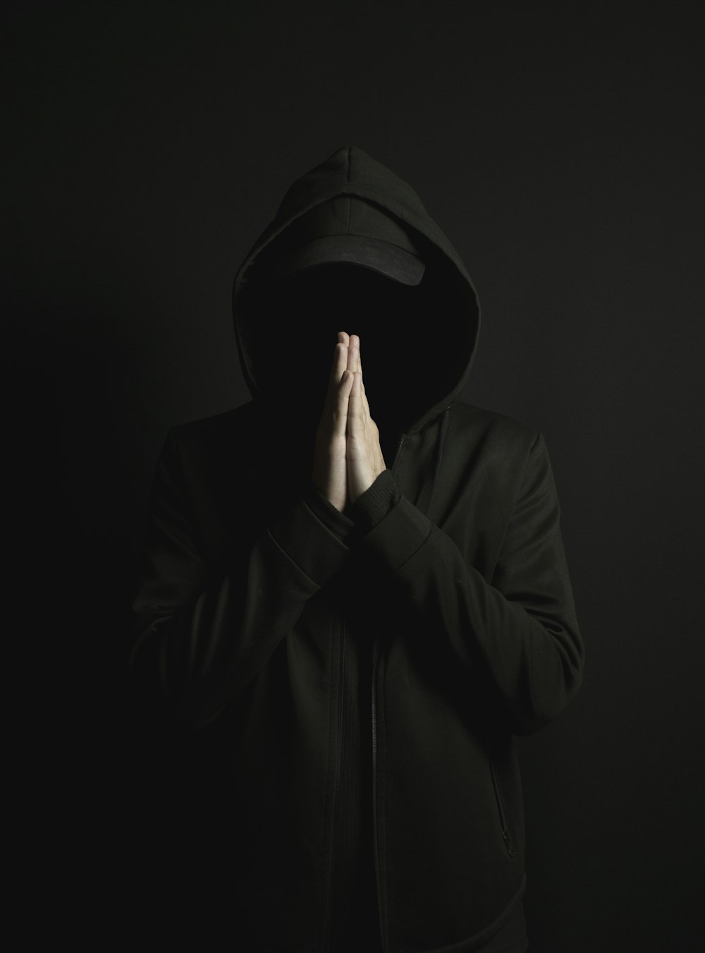A man in a black hoodie is covering his face with his hands photo – Free  Hoodie Image on Unsplash