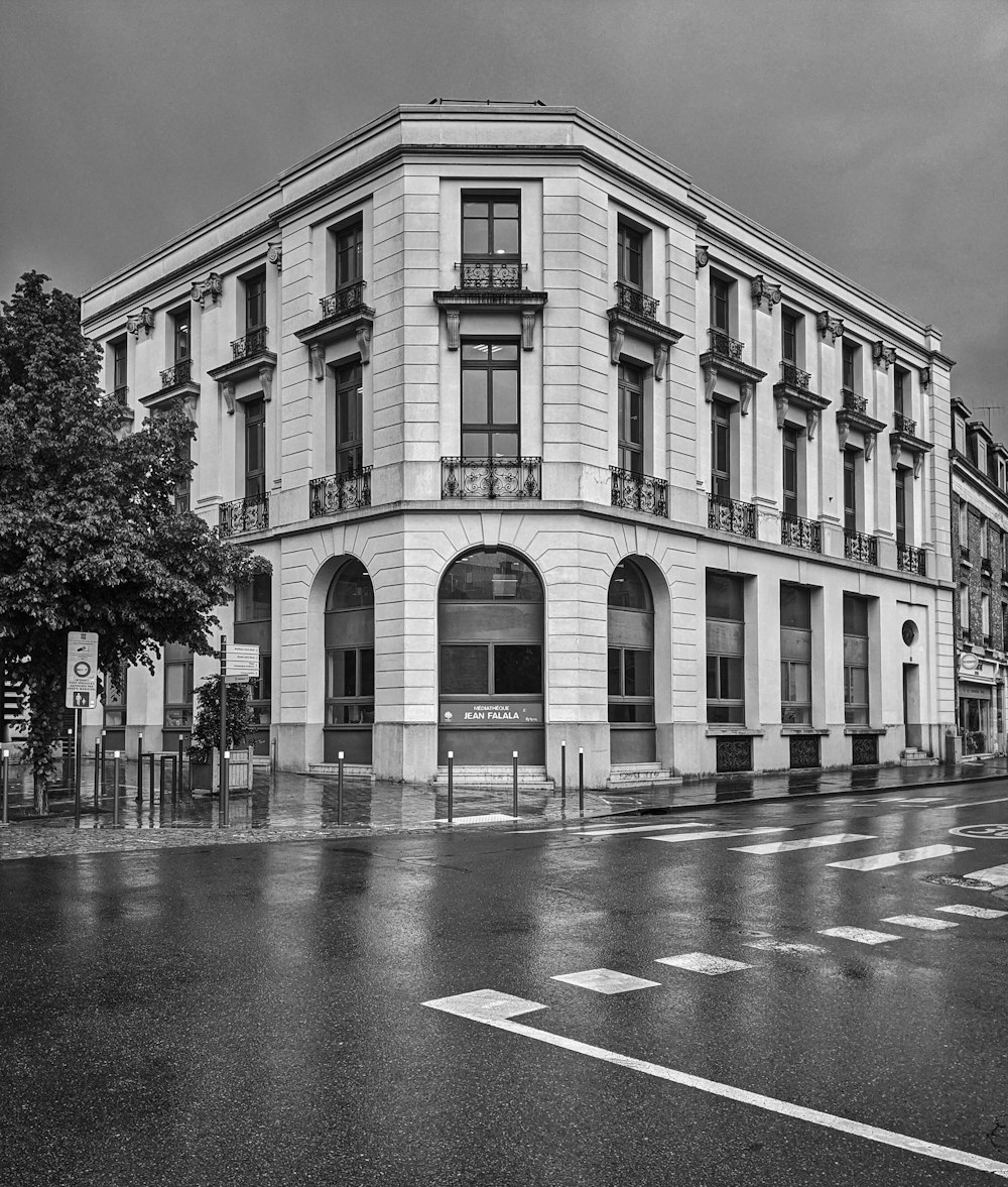 a black and white photo of a building on a rainy day
