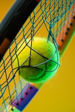 a tennis racket with a tennis ball inside of it