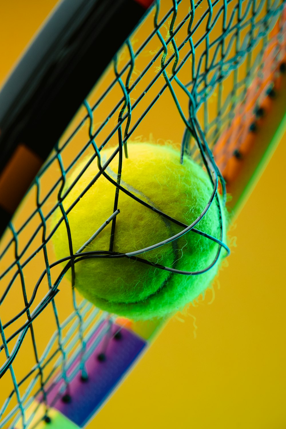 a tennis racket with a tennis ball inside of it