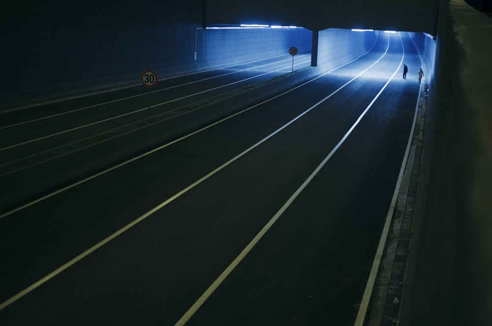 a man is walking through a tunnel in the dark