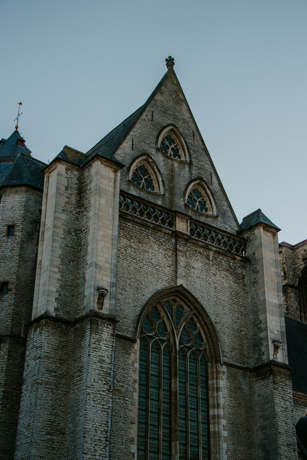 a large stone building with a clock on it's side