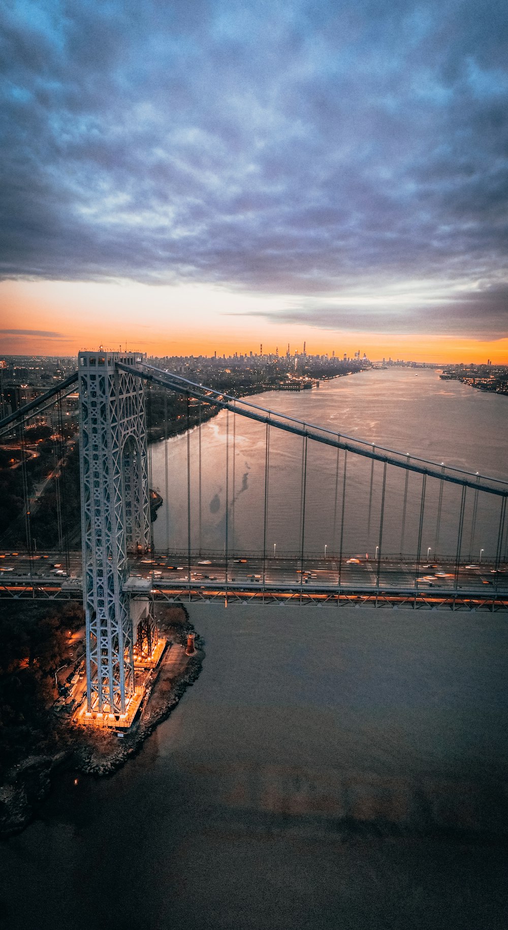 an aerial view of a bridge at dusk