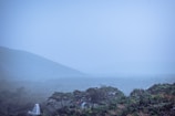 A serene view of the Western Ghats hills covered in morning mist.
