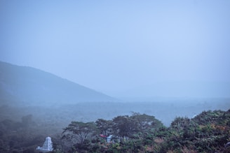 A misty morning view of the Yamunotri temple surrounded by snow-capped peaks.