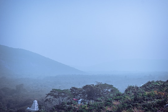 A misty morning view of the Yamunotri temple surrounded by snow-capped peaks.