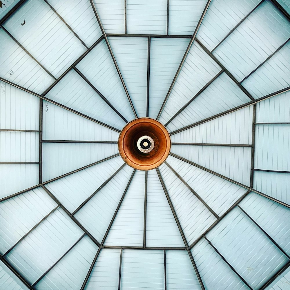 a glass ceiling with a circular light fixture