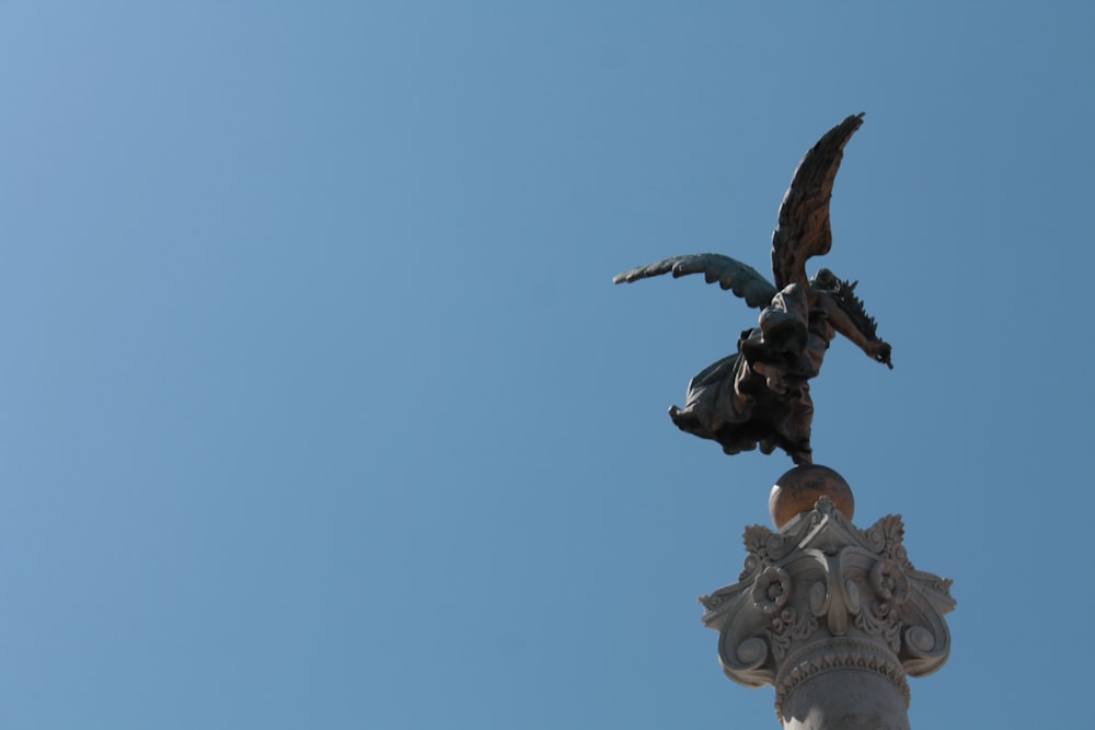 a statue of a bird on top of a building