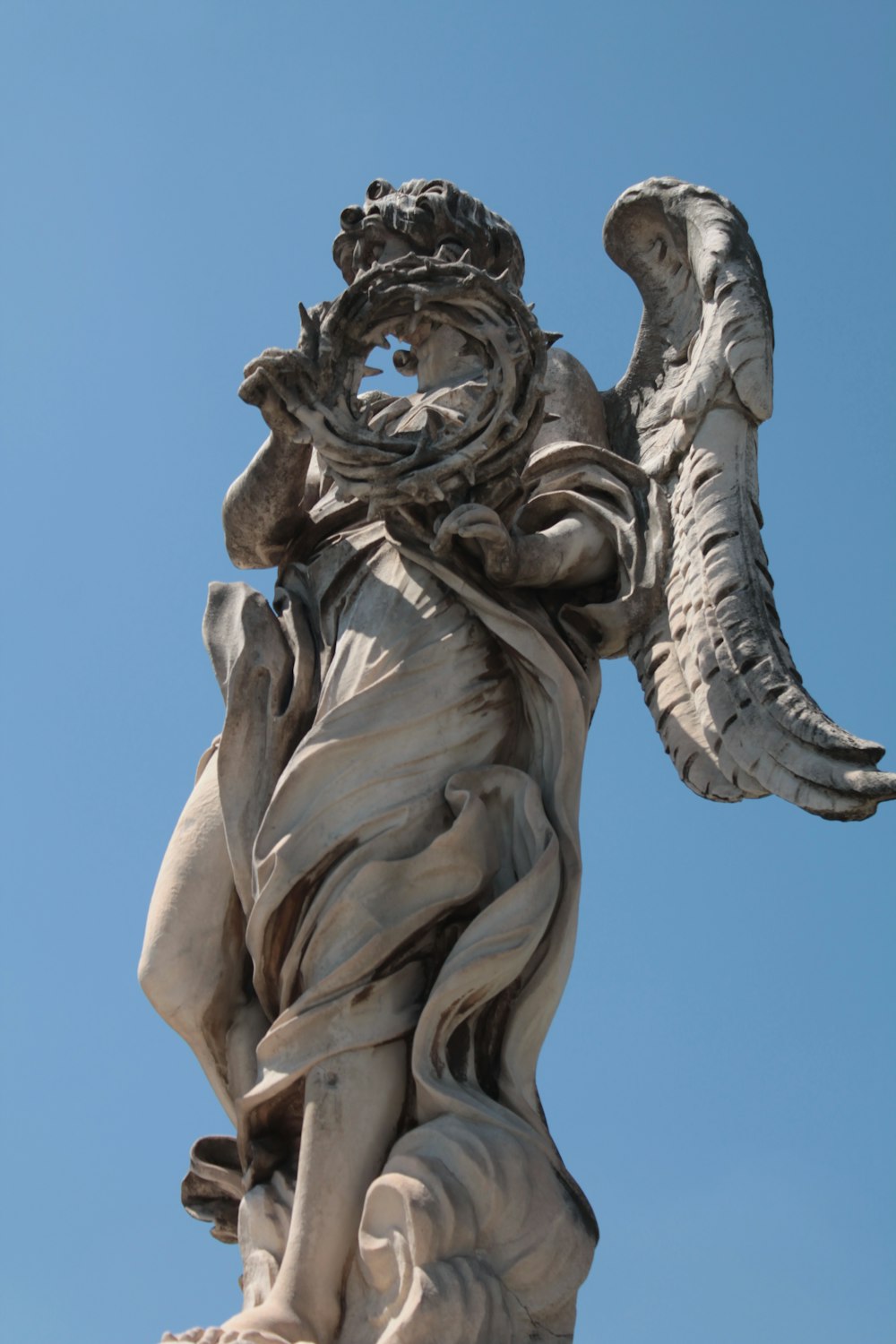 a statue of an angel holding a flower