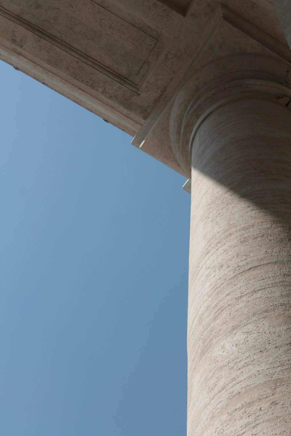 a bird is perched on the top of a pillar