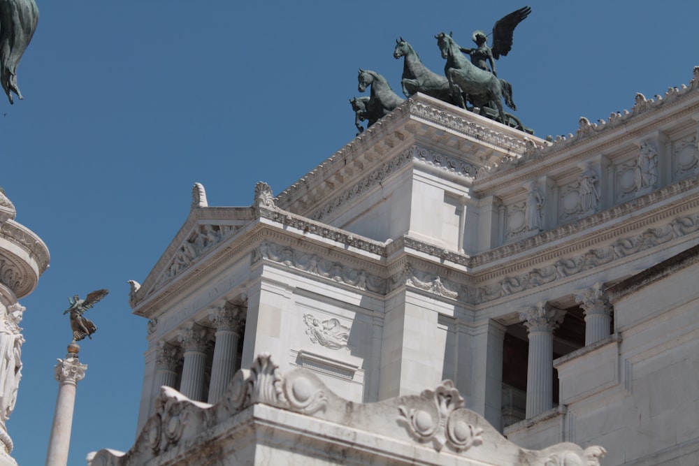 a large building with statues on top of it