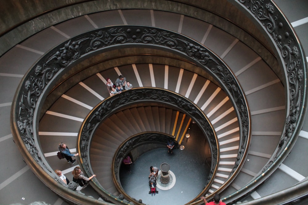 a group of people standing on top of a spiral staircase