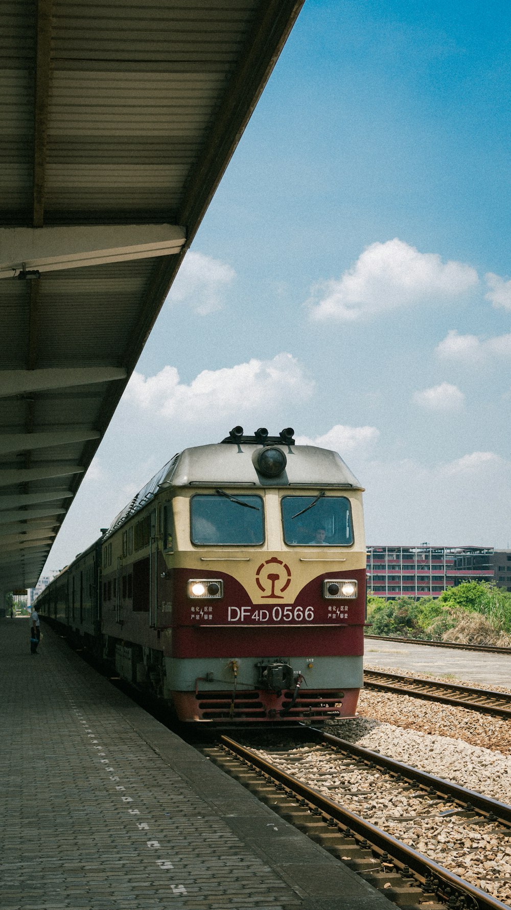 a red and white train pulling into a train station