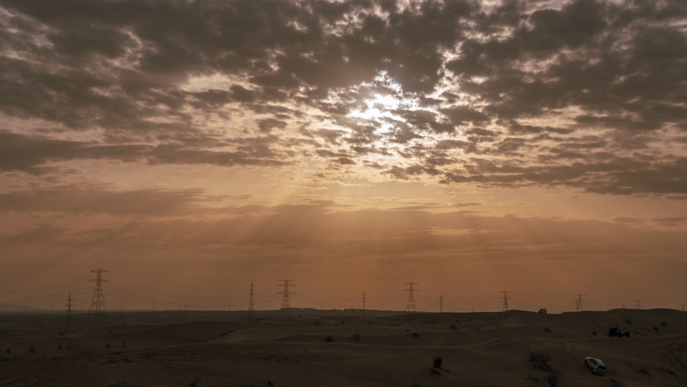 the sun is shining through the clouds over the desert