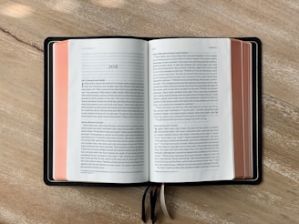 an open book sitting on top of a wooden table