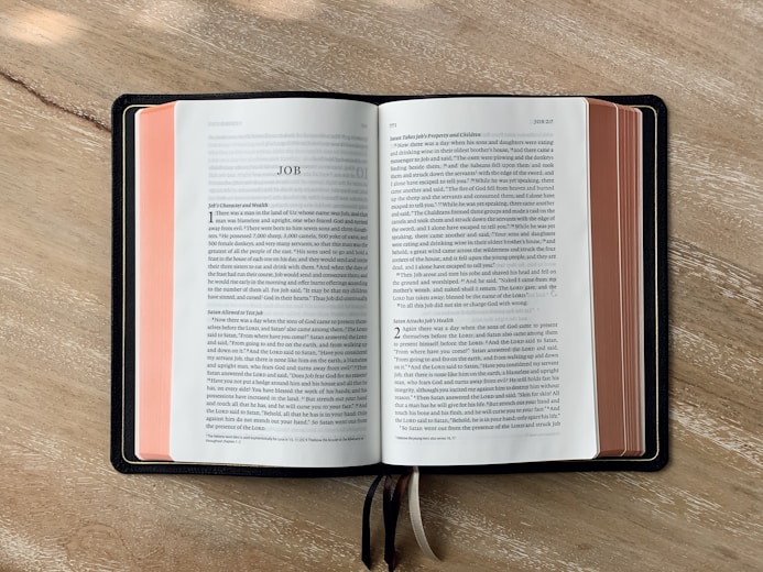 an open book sitting on top of a wooden table