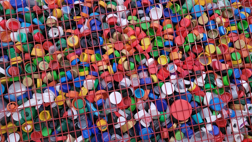 a bunch of different colored objects are in a cage