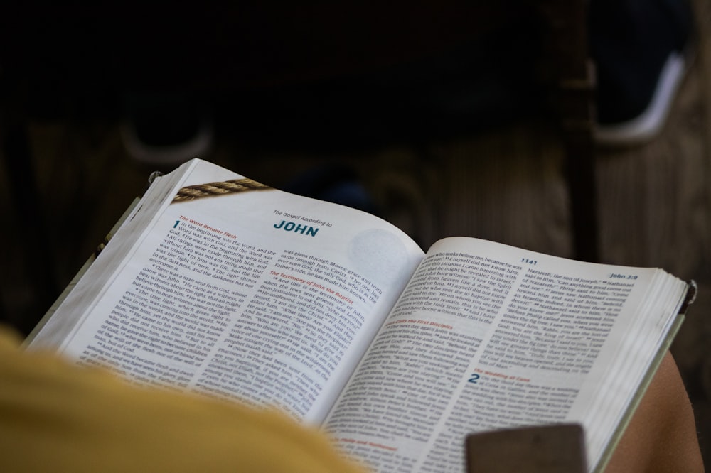 a person is reading a book on the floor