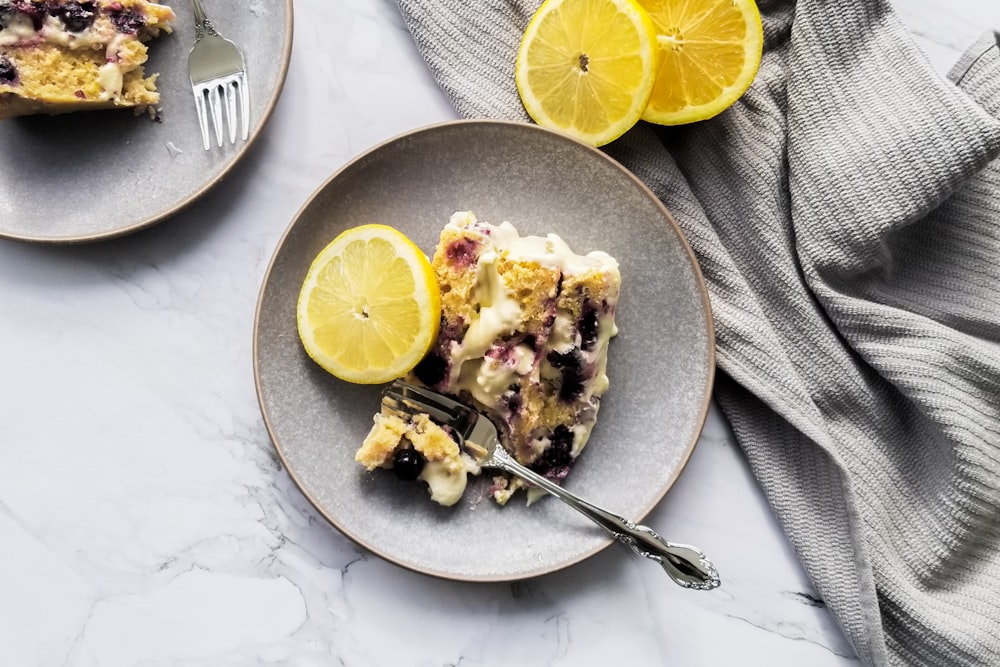 a slice of lemon blueberry pie on a plate with a fork