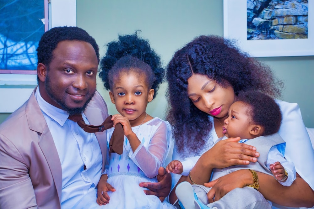 a man, woman, and child are posing for a picture