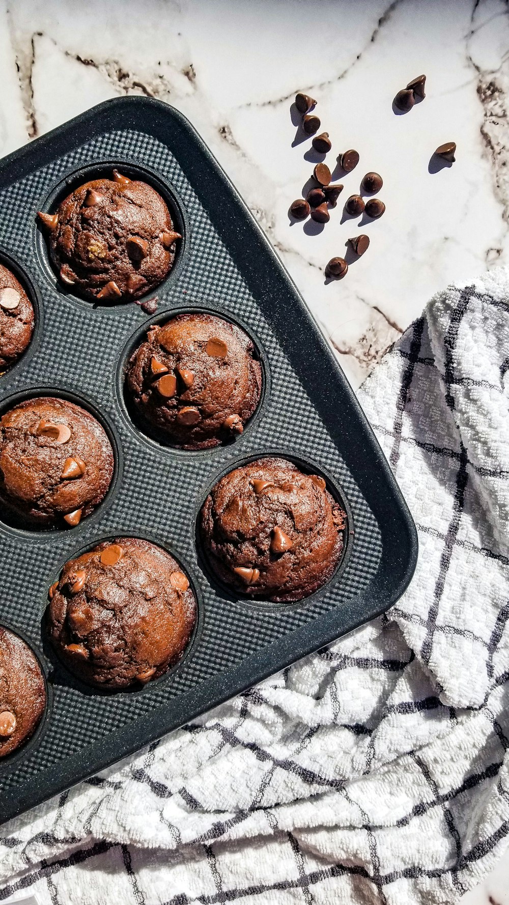 a muffin pan filled with chocolate chip muffins