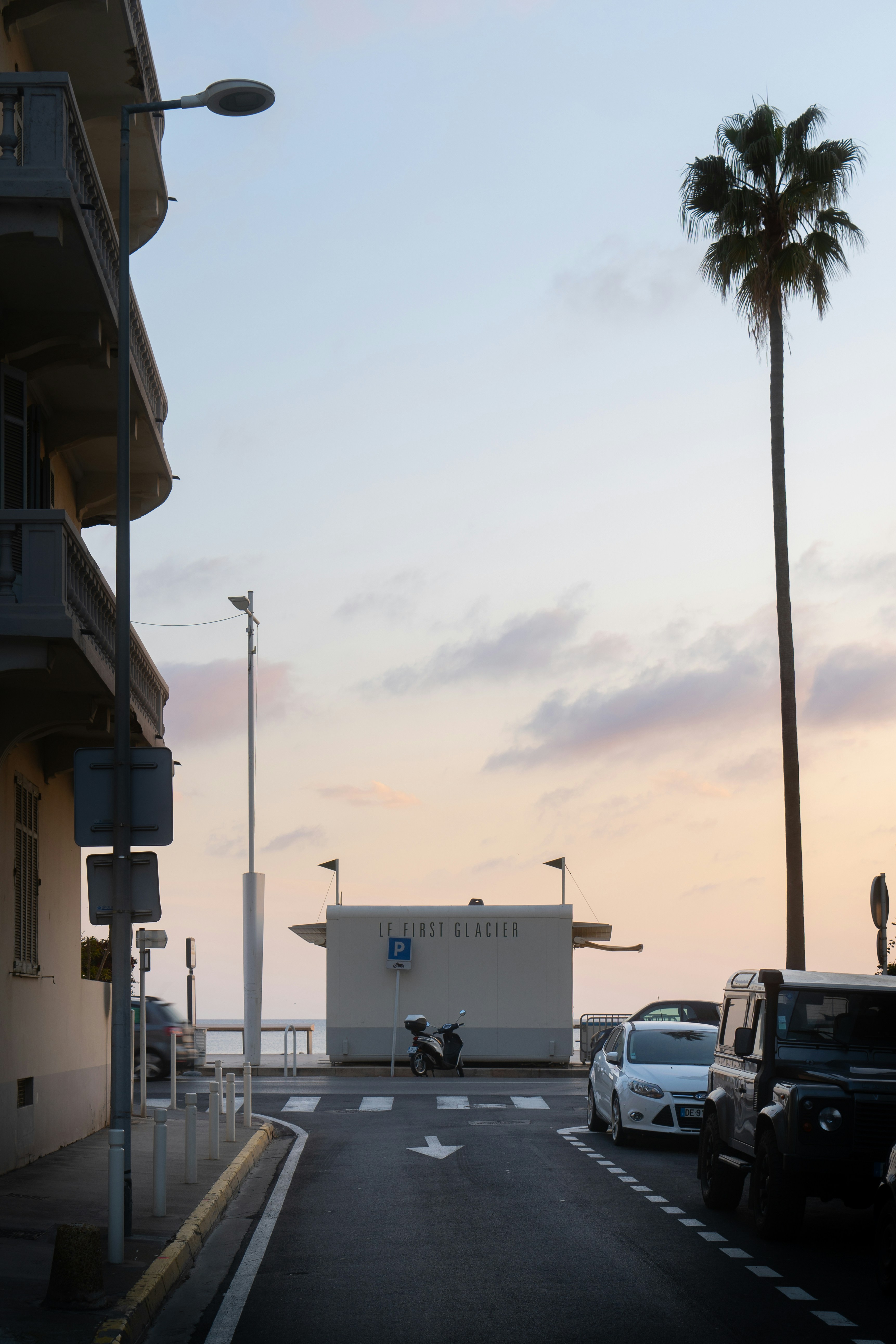 a couple of cars parked on the side of a road