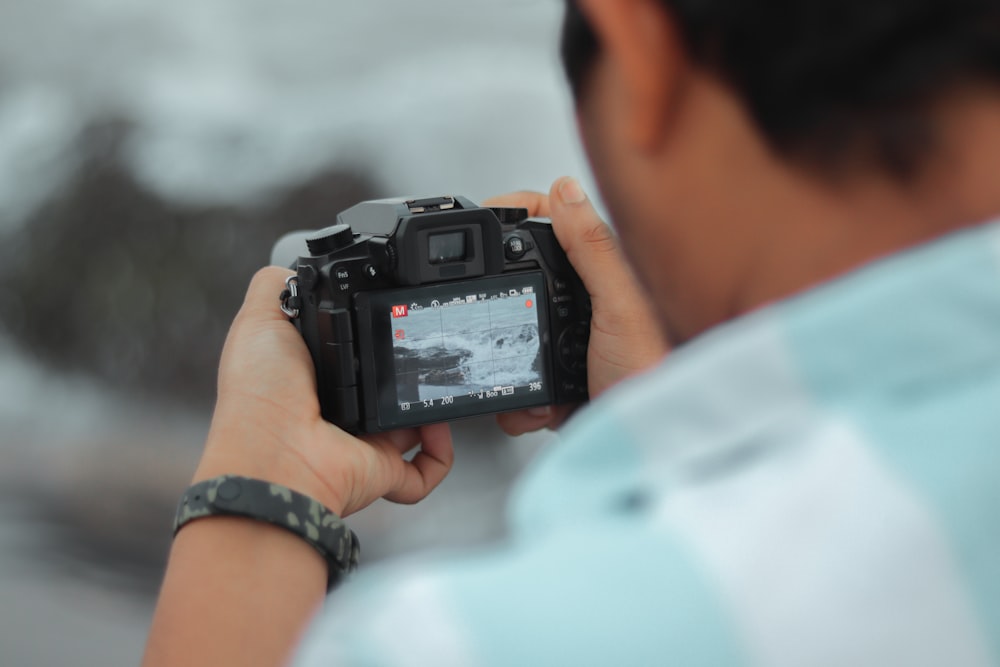 a man holding a camera up to take a picture