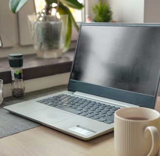 a laptop computer sitting on top of a wooden desk