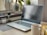 A modern workspace featuring a laptop, notepad, and coffee cup, symbolizing creativity and productivity.