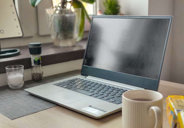 a laptop computer sitting on top of a wooden desk