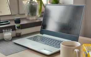 a laptop computer sitting on top of a wooden desk