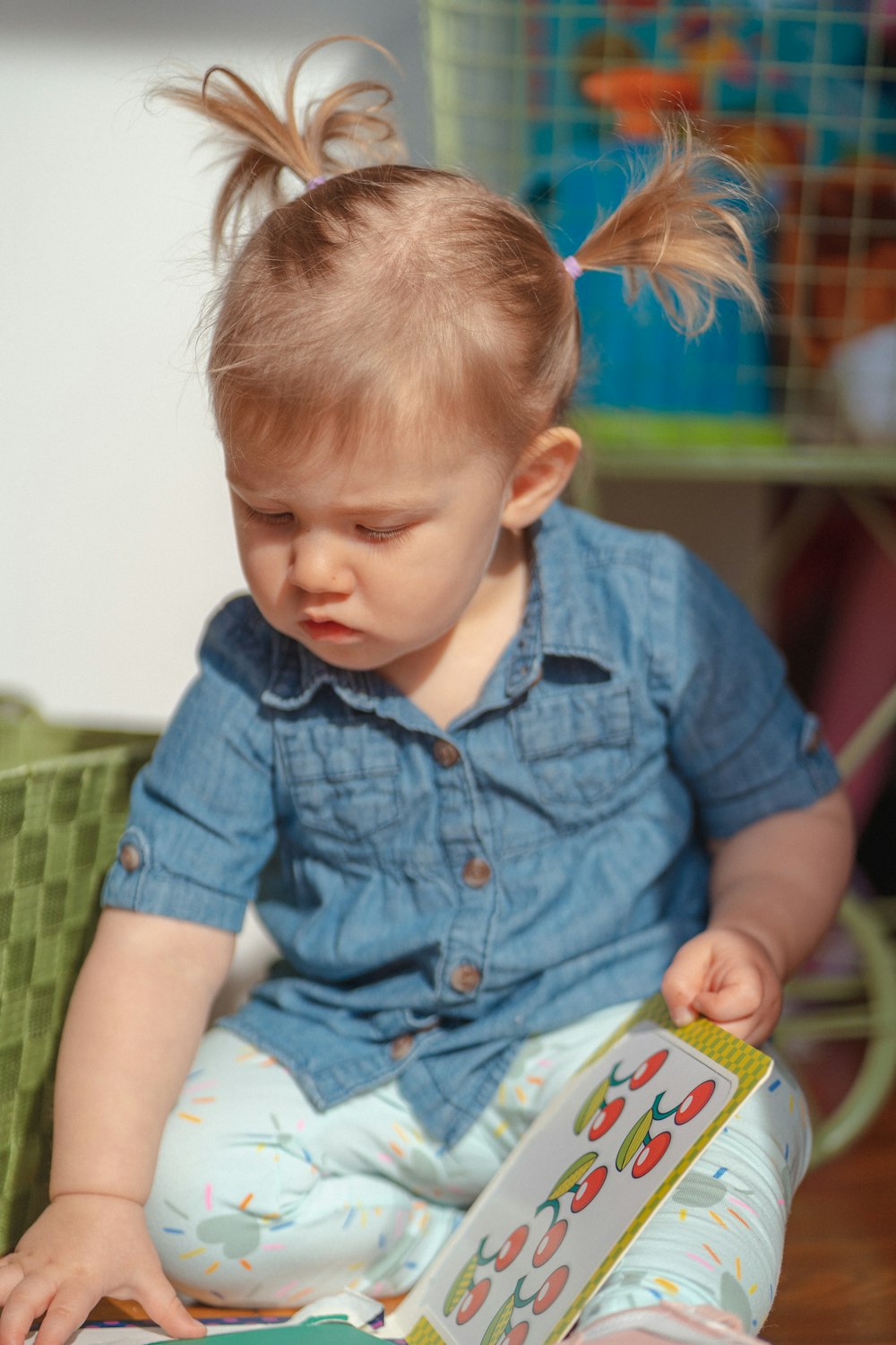 una bambina seduta sul pavimento che legge un libro