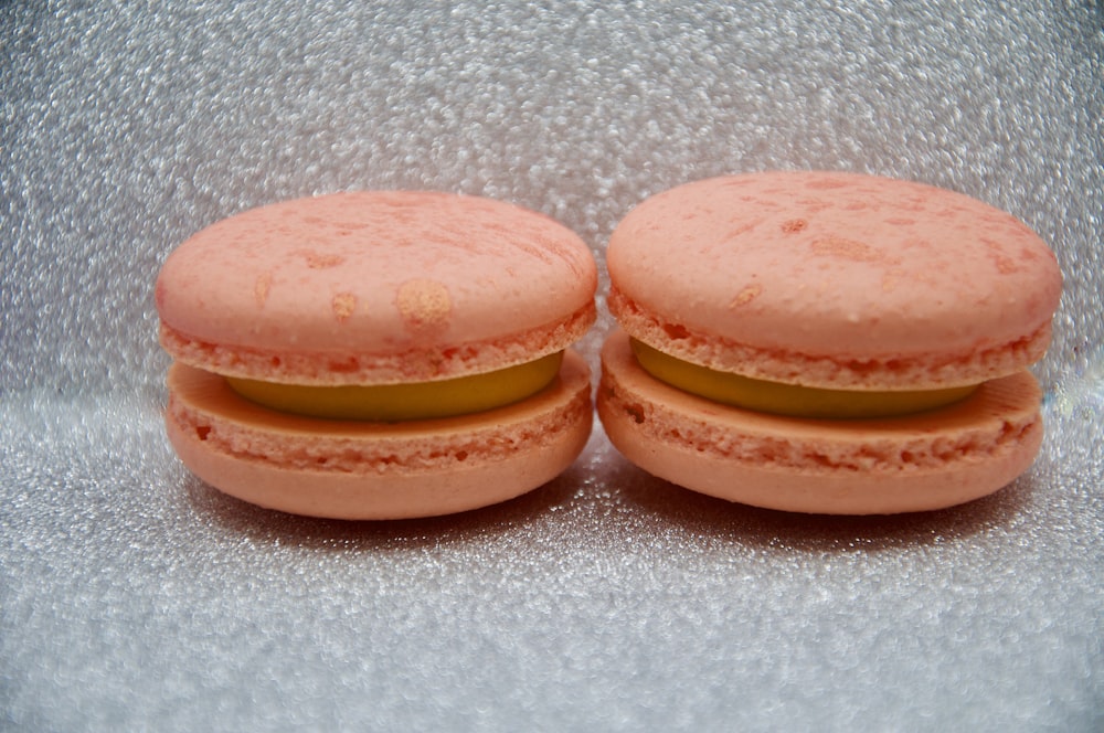 two pink macaroons sitting on top of each other