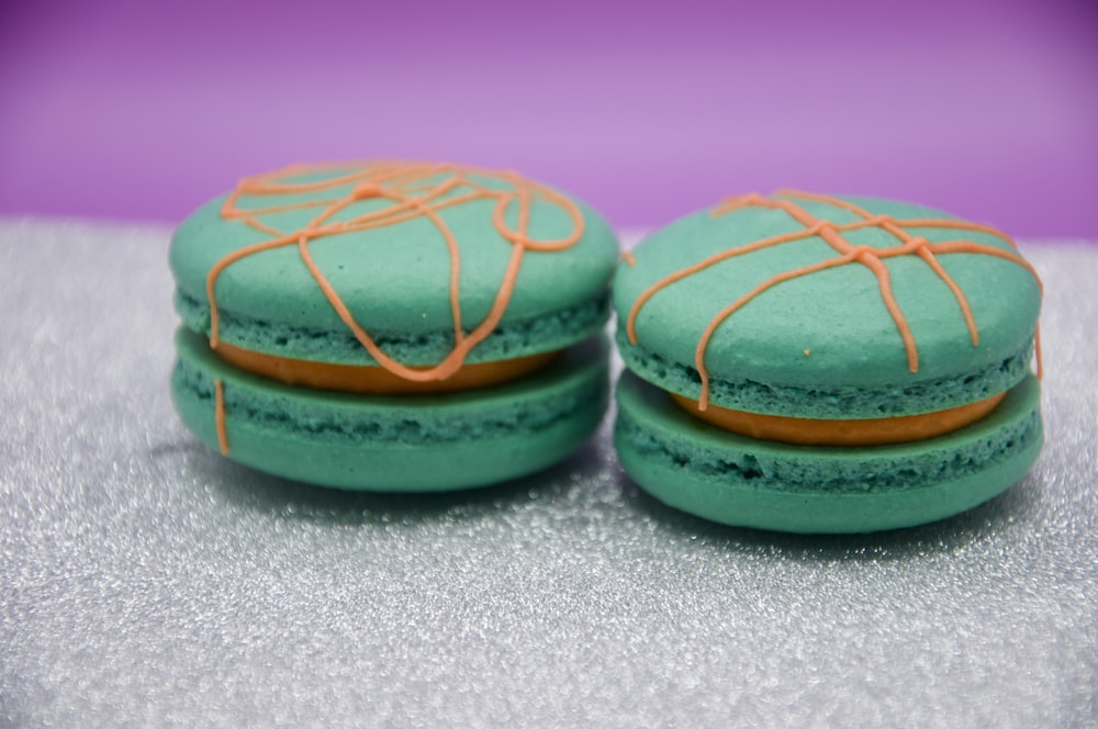 a couple of green macaroons sitting on top of a table