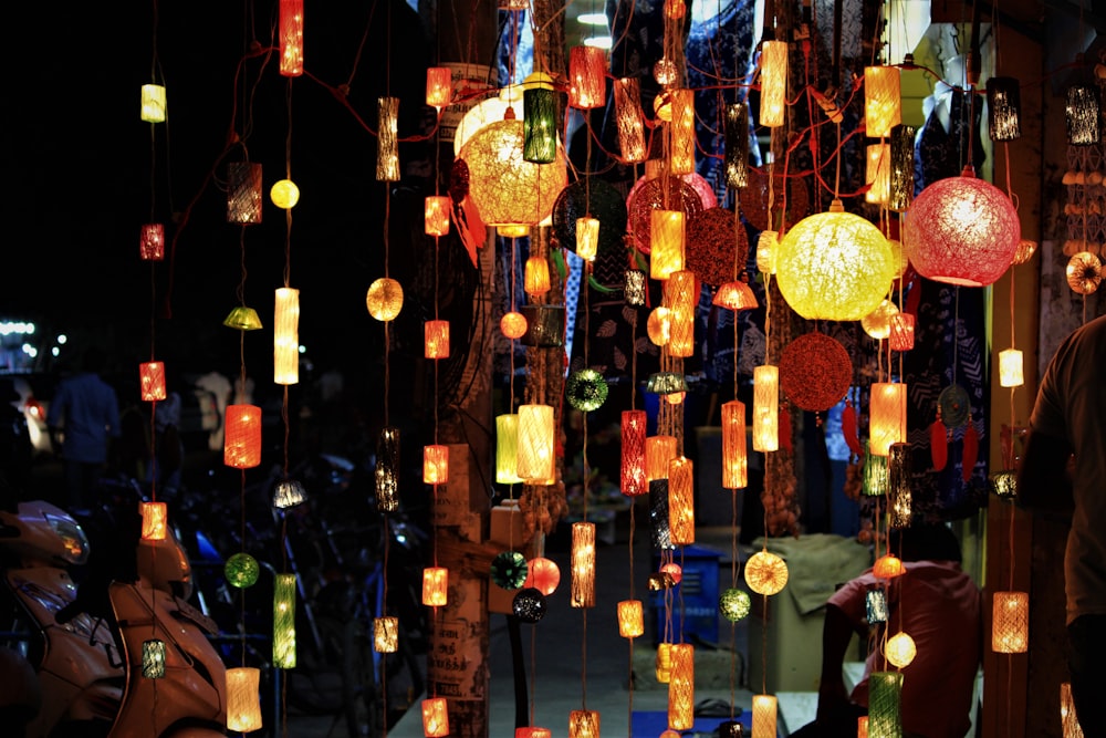 a man standing in front of a display of lanterns