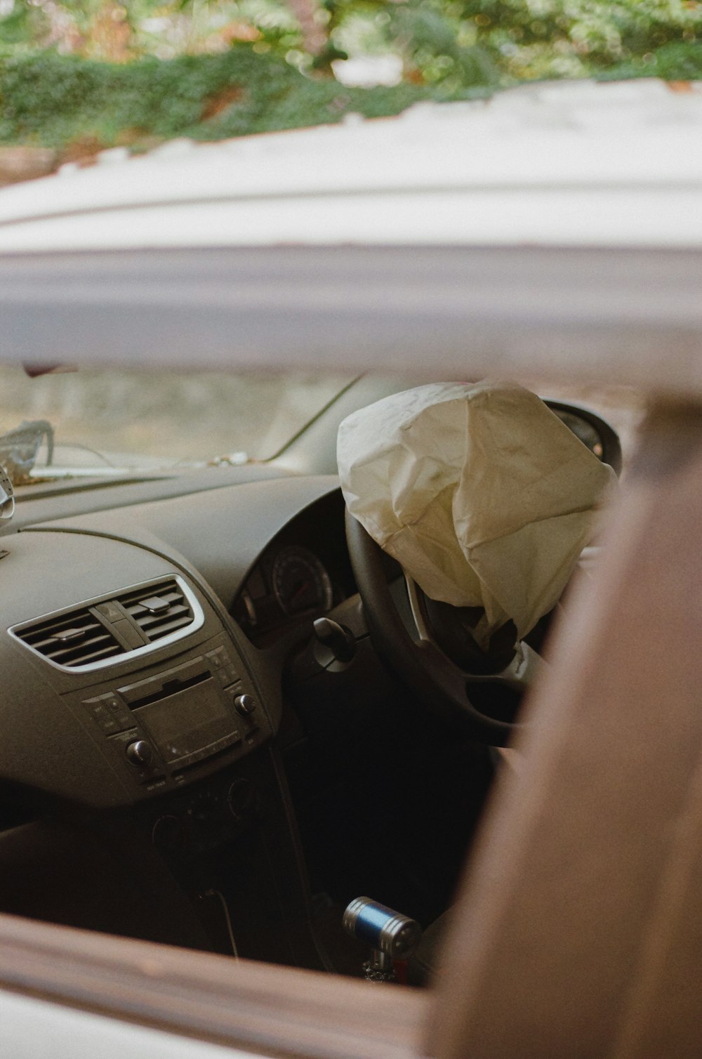 a car with a paper bag in the passenger seat