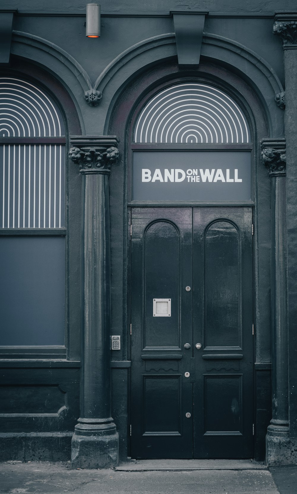 a black building with a band on the wall sign