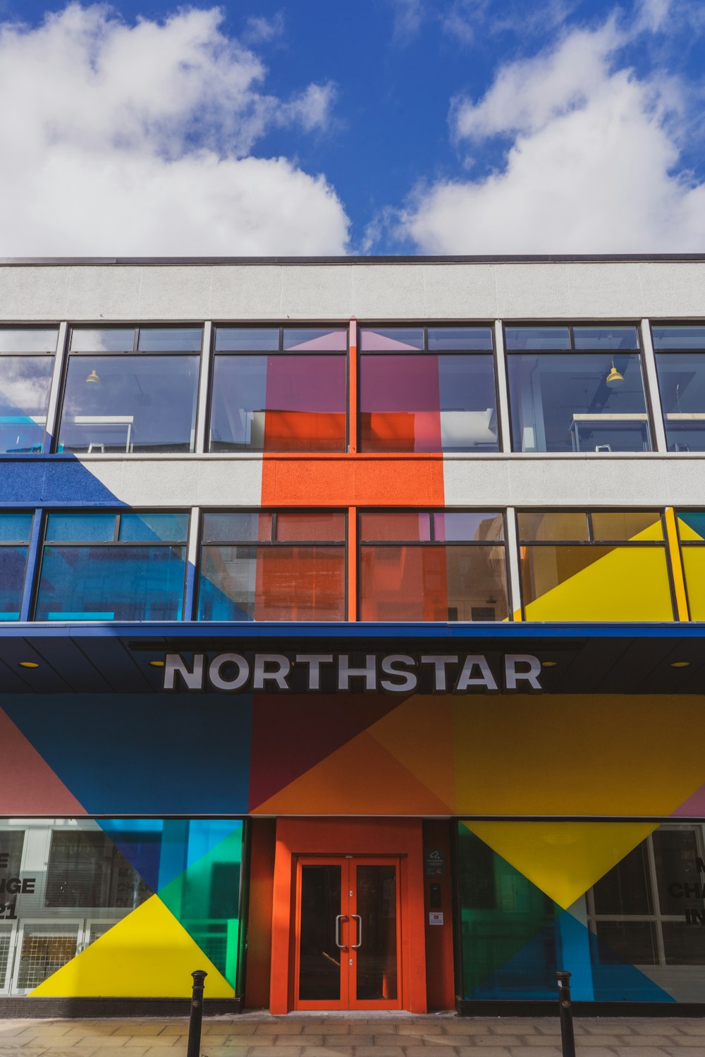 a multicolored building with a blue sky in the background