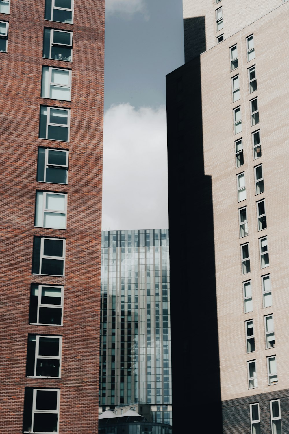 a couple of tall buildings sitting next to each other