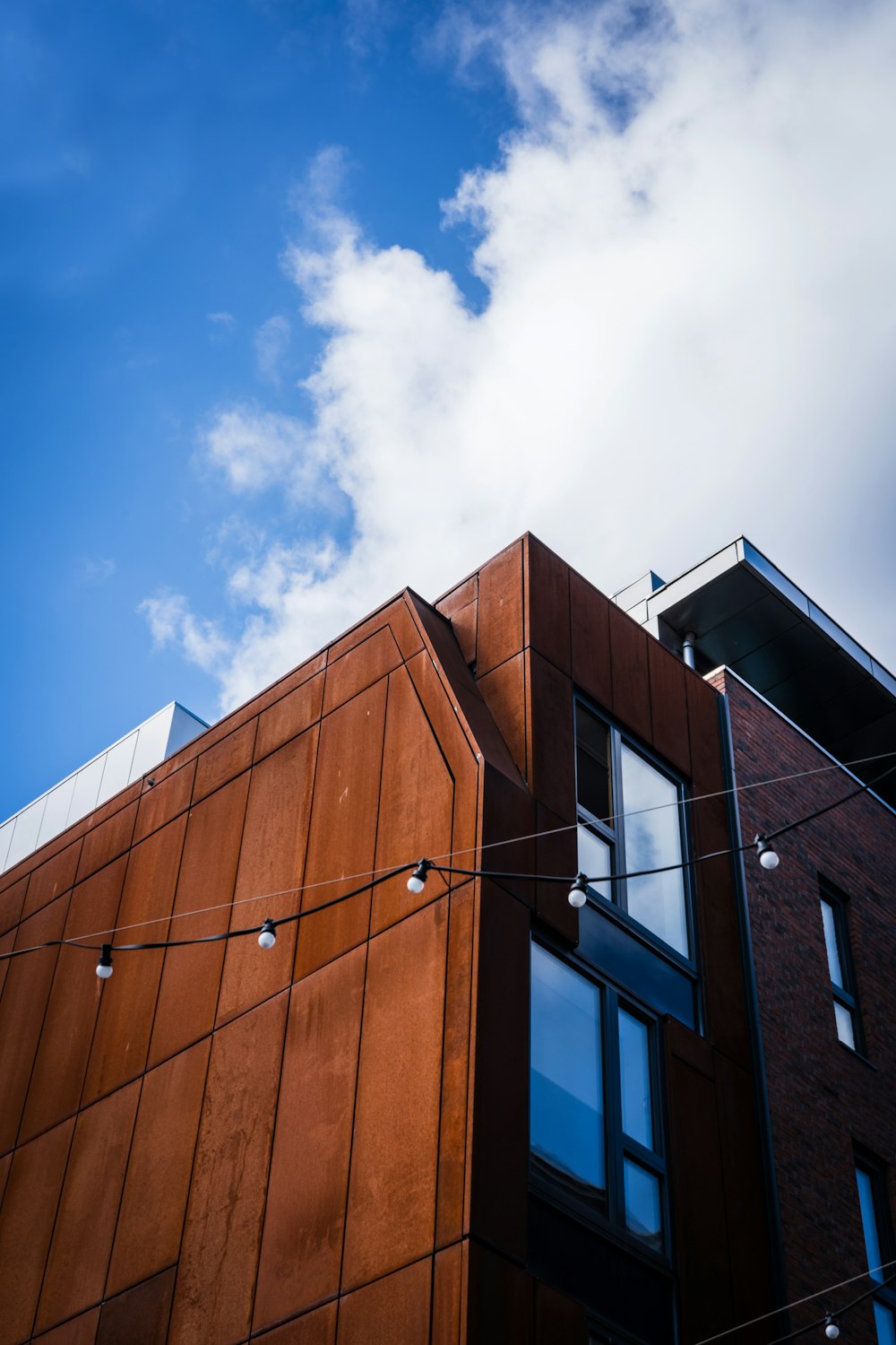 a brown building with a blue sky in the background