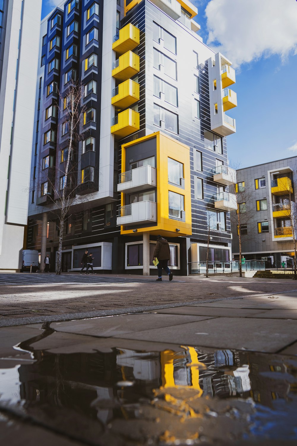 a tall building with yellow and white balconies