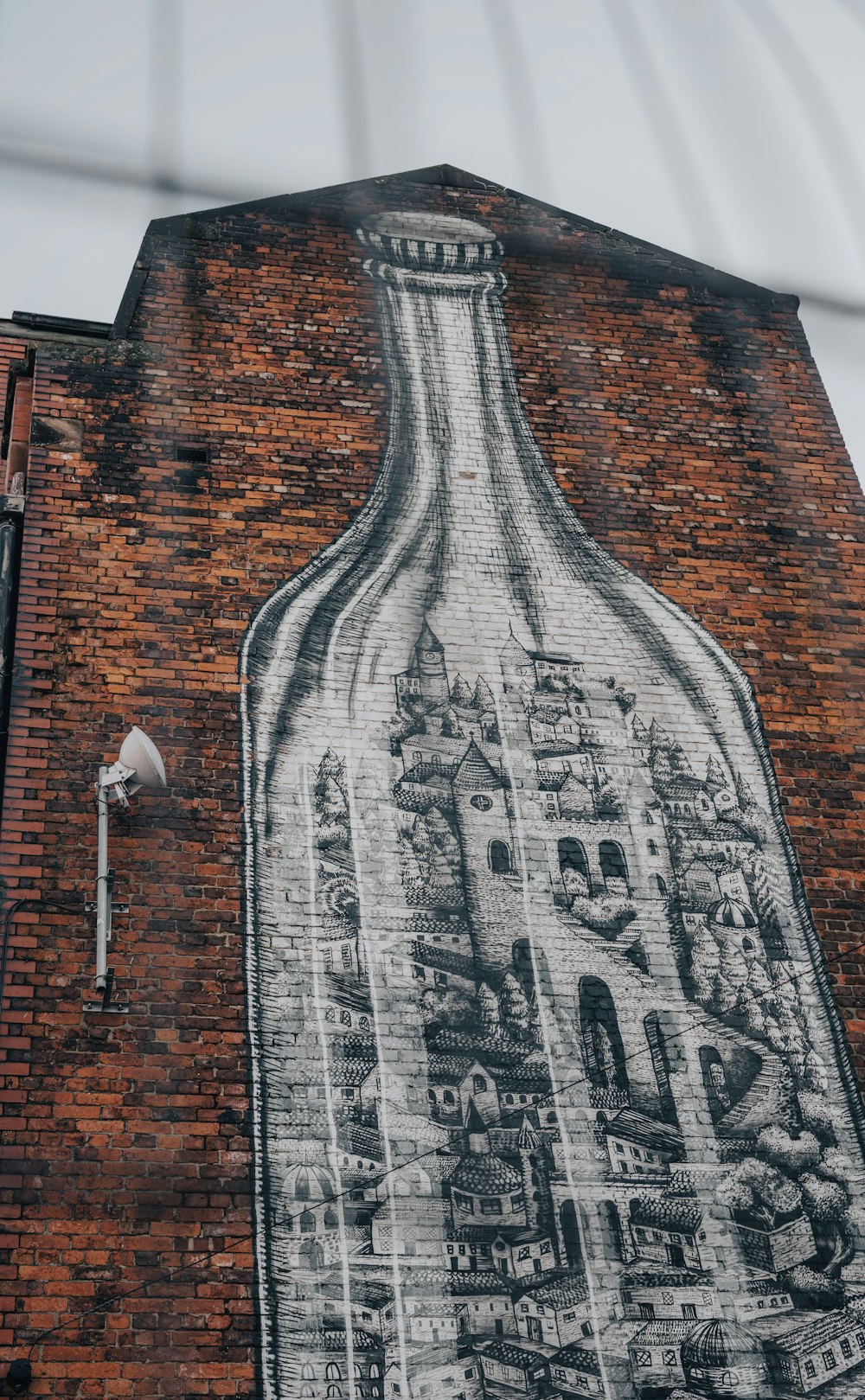 a large mural on the side of a brick building