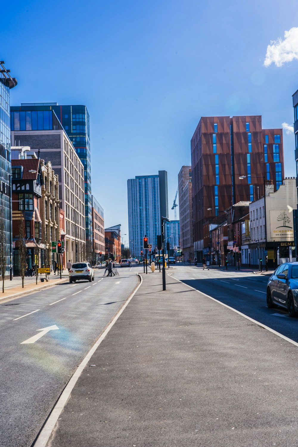 a city street with cars driving down it