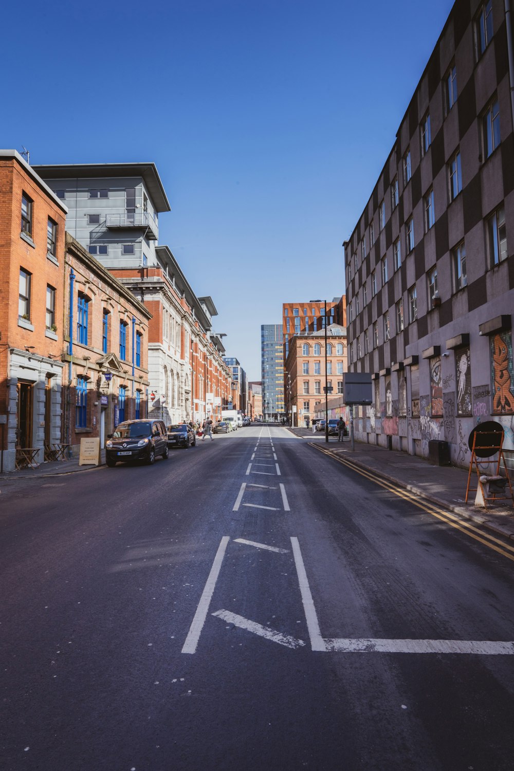 a city street with cars parked on both sides