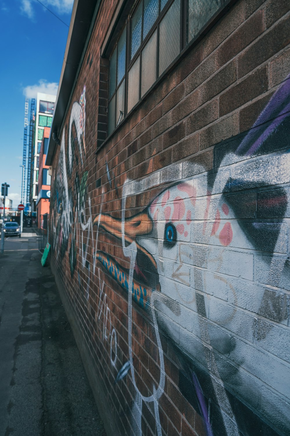 a brick wall with a picture of a cow painted on it