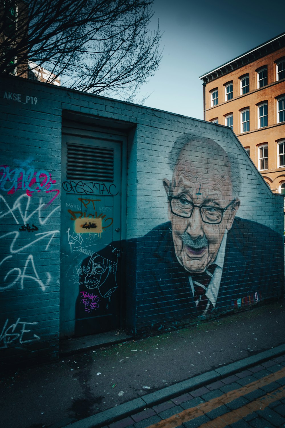 a painting of a man with glasses on a wall
