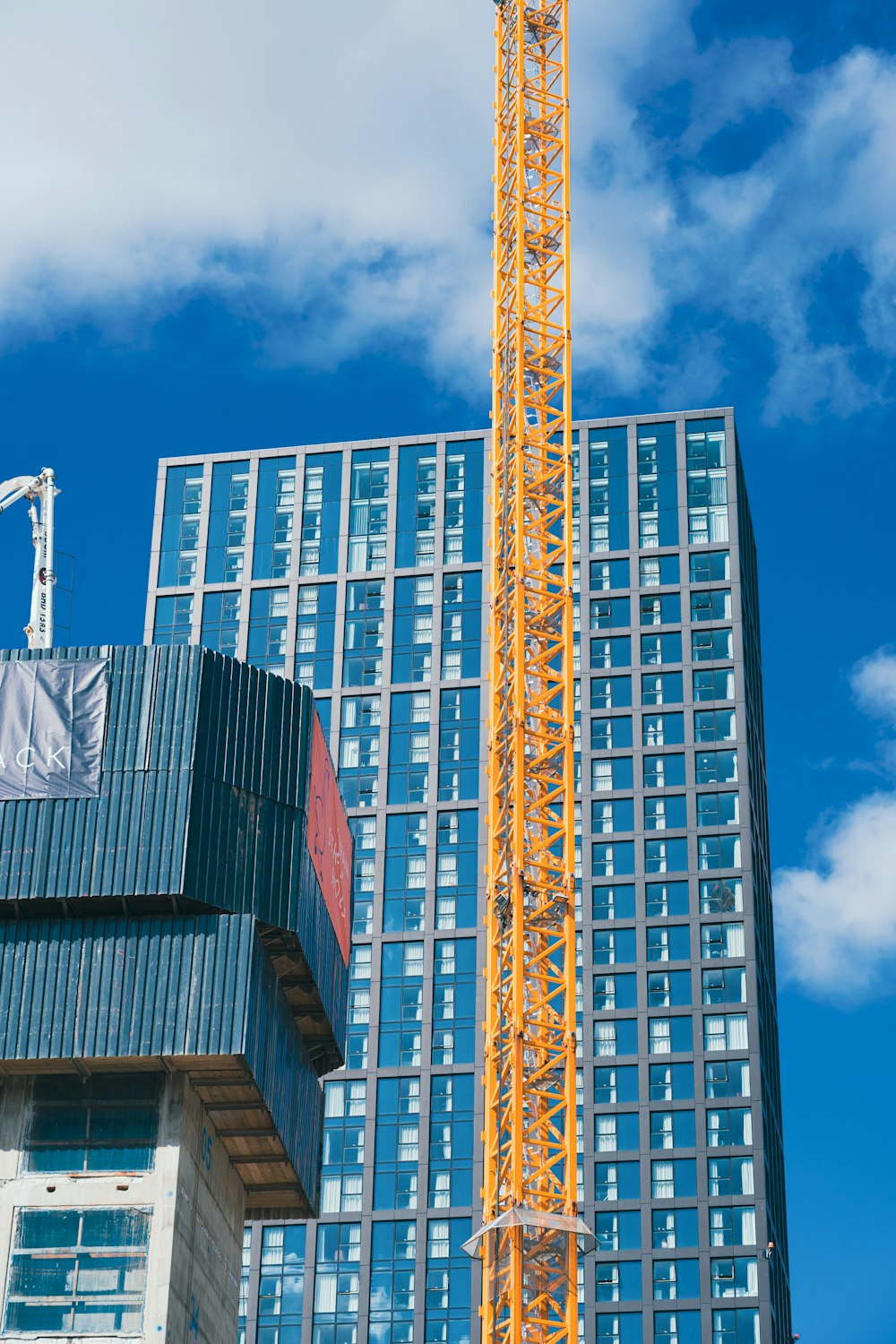 a crane is standing in front of a tall building