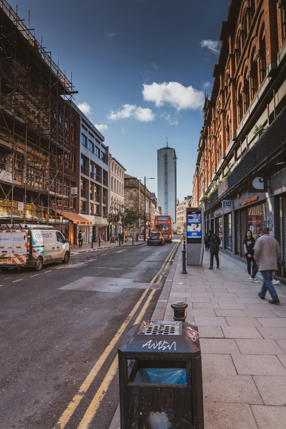 a city street with scaffolding on the buildings