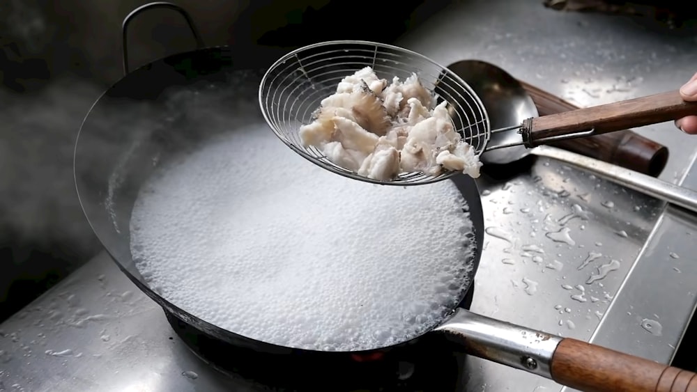 a frying pan filled with food on top of a stove