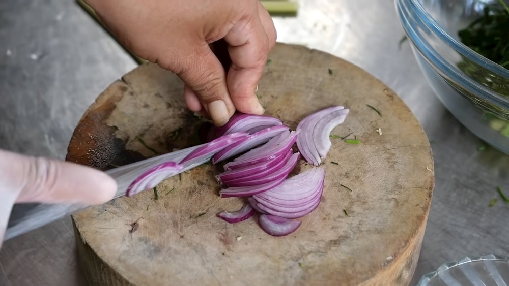 a person chopping onions on a cutting board